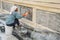 Woman renovates a wall iof a temple in the inner Grand Palace opf the Thai King