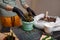 Woman replanting flower seedling into new flower pot, putting in some universal soil for home potted plants