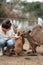 Woman in the reserve is playing with a kangaroo