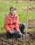 Woman resetting raspberry sprouts