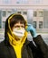 Woman in respirator and rubber gloves in urban scape, pandemic virus protective mask, air pollution problem