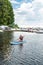 woman rest at paddle boards on a bay or city lake.