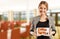 Woman restaurant manager holding tablet with menu