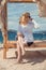 Woman resting on the beach in a gazebo