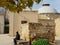 A woman is resting on a bench outside the Omerye Hamam in the old town of Nicosia, Cyprus