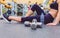 Woman resting and friend doing dumbbells exercises