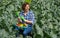 woman resting after work in the field and puts protective gloves on his hands