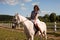 The woman restores her mental health by riding a horse