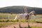 The woman restores her mental health by riding a horse