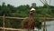 The woman returns home after a day out to work on a bamboo bridge