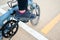 Woman ride the bike, with traffic lines on the asphalt road