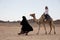 Woman ride in camel desert location