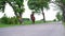 Woman ride on horseback along a road. Horsewoman wearing brown hat ride on a horse