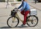 Woman rides a bicycle in a protective mask