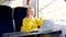 a woman rides in a train a seated car works on a laptop at a table A fair middle-aged woman advertises a phone showing a