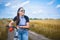 Woman is riding bicycle outside in the field