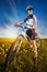 Woman is riding bicycle outside in the field