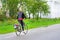 Woman riding a bicycle on the road in the village