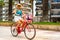 Woman riding bicycle on seaside boulevard