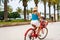 Woman riding bicycle on seaside boulevard