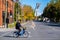 Woman riding a Bixi bike on Rachel street in Autumn