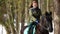 A woman riding a brown beautiful horse in the winter forest