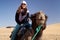 Woman riding a camel