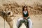 Woman riding camel