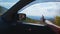 A woman riding in a car on autumn day