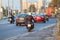 Woman riding on city street on her bike, rear view on the urban road