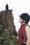 Woman In Riding Hat With Horse Outdoors