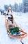 Woman riding Husky dog sled in Finland in Lapland winter reflex