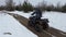 Woman Riding on a Quad Bike on a Snow Covered Path in Winter
