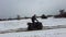 Woman Riding on a Quad Bike on a Snow Covered Path in Winter