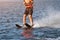 Woman riding water skis closeup. Body parts without a face. Athlete water skiing and having fun. Living a healthy