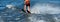 Woman riding water skis closeup. Body parts without a face. Athlete water skiing and having fun. Living a healthy