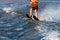 Woman riding water skis closeup. Body parts without a face. Athlete water skiing and having fun. Living a healthy