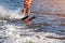 Woman riding water skis closeup. Body parts without a face. Athlete water skiing and having fun. Living a healthy
