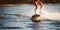 Woman riding water skis closeup. Body parts without a face. Athlete water skiing and having fun. Summer by the sea. Generative AI