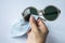 Woman right hand cleaning sunglasses by microfibre cleaning cloths, On white background, Close up & Macro shot, Optical concept