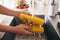 Woman rinsing fresh corns by hands in the kitchen-sink. Going to prepare salad.