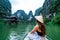 A woman on a river boat in Ninh Binh. Mountains of northern Vietnam.