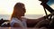 Woman, road trip and freedom at sunset at the sea in a car with drive for holiday, adventure and travel outdoor
