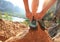 Woman rock climber tying shoelace at mountain rock