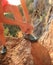 Woman rock climber tying shoelace on rock