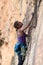 Woman rock climbs vertical cliff face at Walls Ledge Porters Pass Centennial Glen Circuit in Blue Mountains National Park NSW