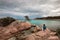 Woman on the rocks of Capriccioli beach, Costa Smeralda, Italy