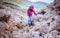 Woman On The Rocky Beach In Rhossili Bay, Walesh Coast Path, Wa