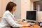 Woman roentgenographer in office clinic is browsing digital images