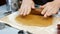 Woman roll out the dough with rolling pen. Making christmas gingerbread cookies